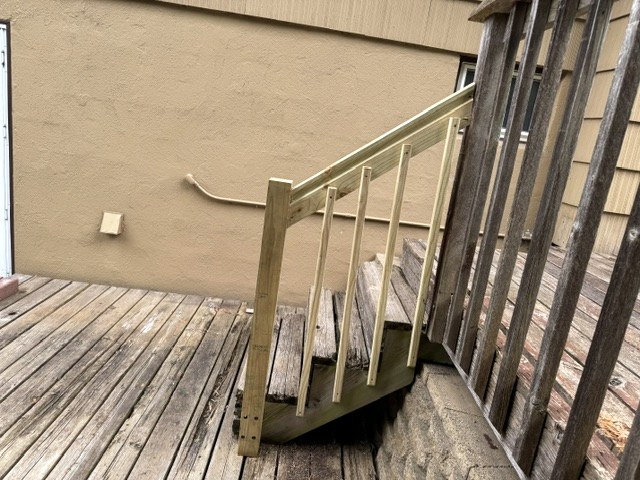 New wood stair railing and balusters on a set of deck stairs